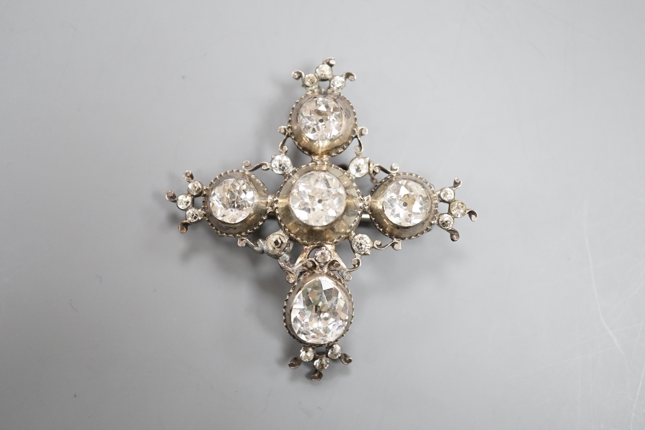 A 19th century white metal and paste cluster set quatrefoil shaped pendant brooch, 56mm, (a.f.).